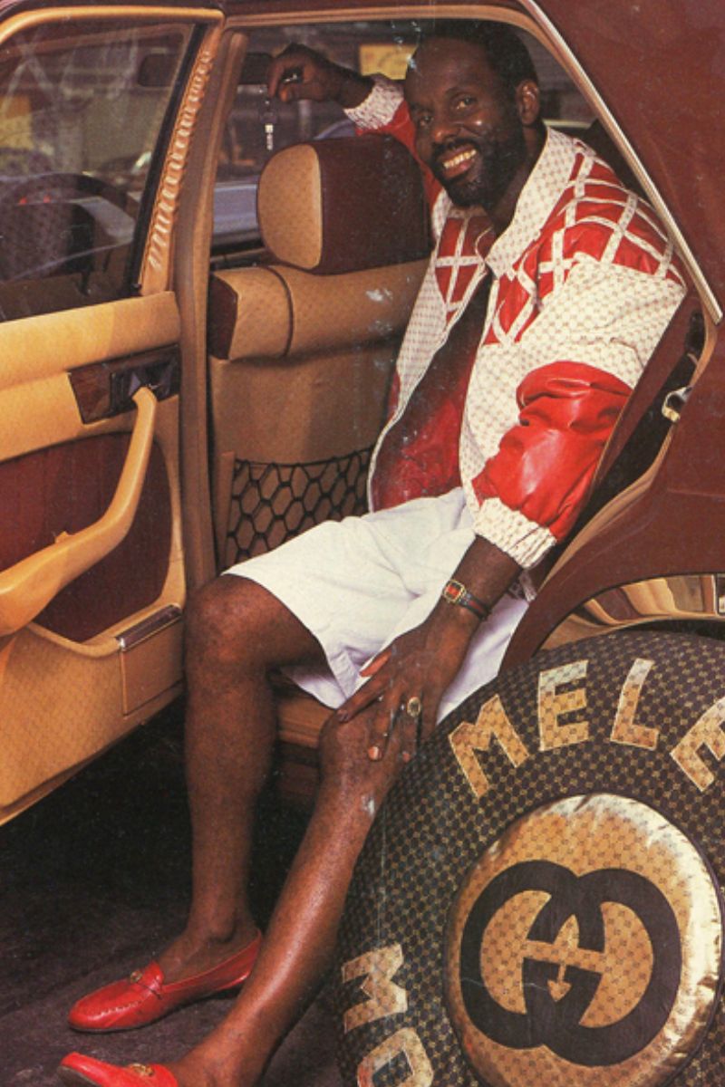 Dapper Dan in the 1980s posing inside a car