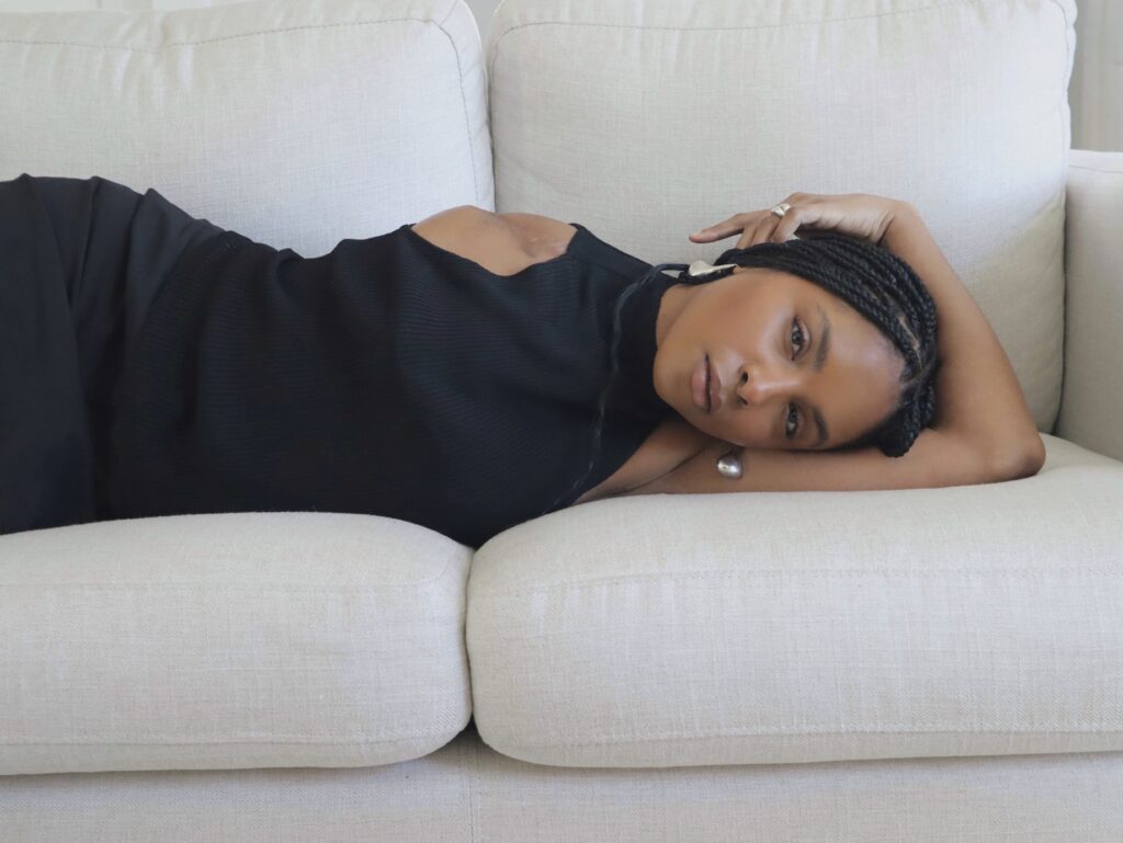 Photo of Maya Moore posing on a couch